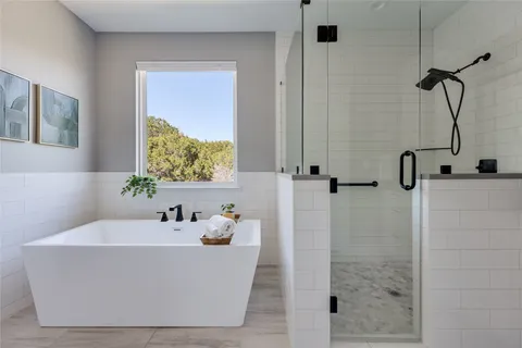 a white bath tub sitting next to a bathroom sink