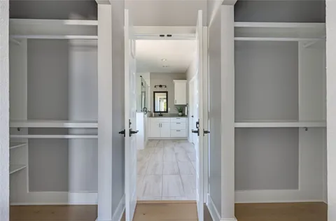 a view of a hallway with wooden floor