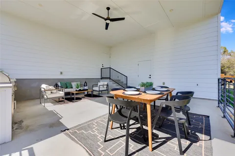 a view of a patio with a table and chairs