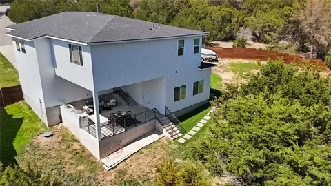 a aerial view of a house with table and chairs