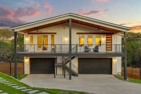 a front view of a house with yard and parking