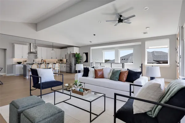 a kitchen with stainless steel appliances kitchen island granite countertop a dining table chairs and white cabinets