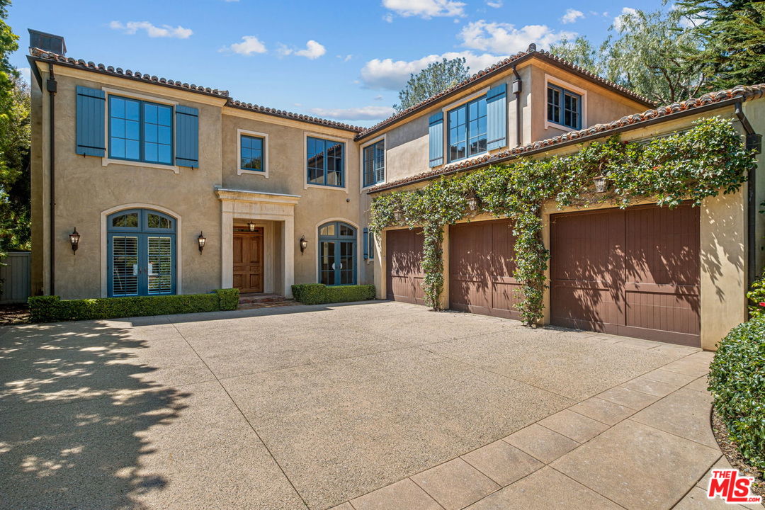 702 Patterson Place Pacific Palisades, CA 90272 - Photo 3 of 18 a front view of a house with a yard and garage
