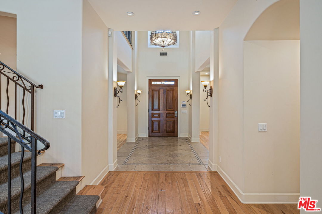 702 Patterson Place Pacific Palisades, CA 90272 - Photo 5 of 18 a view of a hallway with wooden floor and staircase