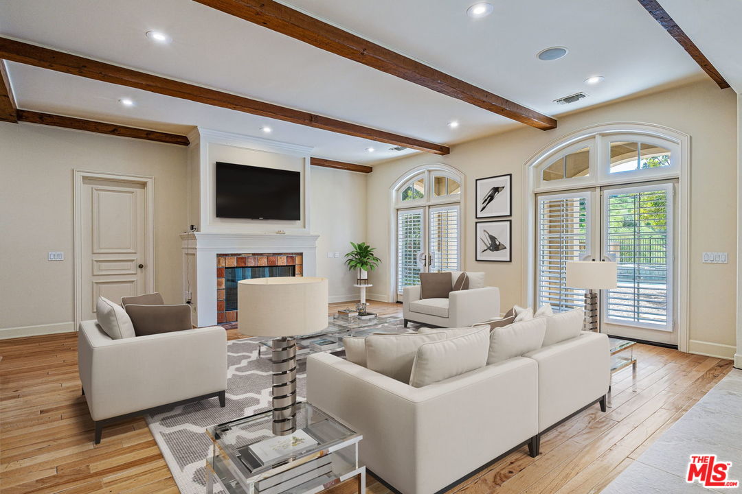 702 Patterson Place Pacific Palisades, CA 90272 - Photo 8 of 18 a living room with fireplace furniture and a flat screen tv