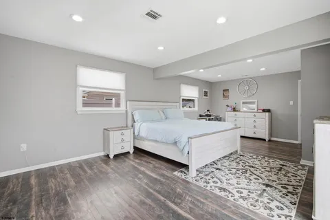 a spacious bedroom with a bed and a window