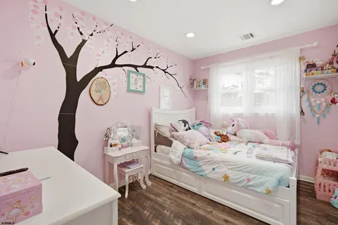 a bedroom with furniture and a window