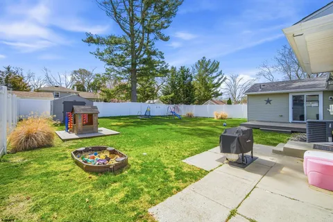 a view of an house with backyard space and garden