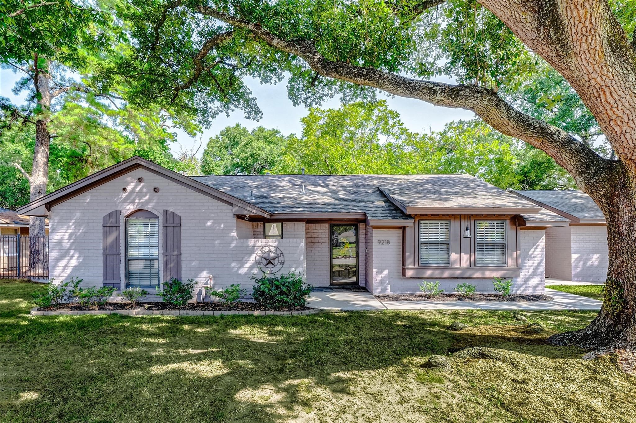 9218 Hammerly Boulevard Houston, TX 77080 - Photo 1 of 40 a front view of a house with a yard