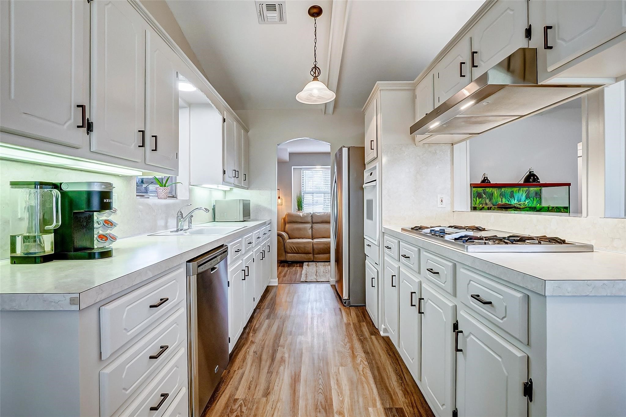 9218 Hammerly Boulevard Houston, TX 77080 - Photo 15 of 40 a large kitchen with stainless steel appliances granite countertop a lot of counter space and wooden floors