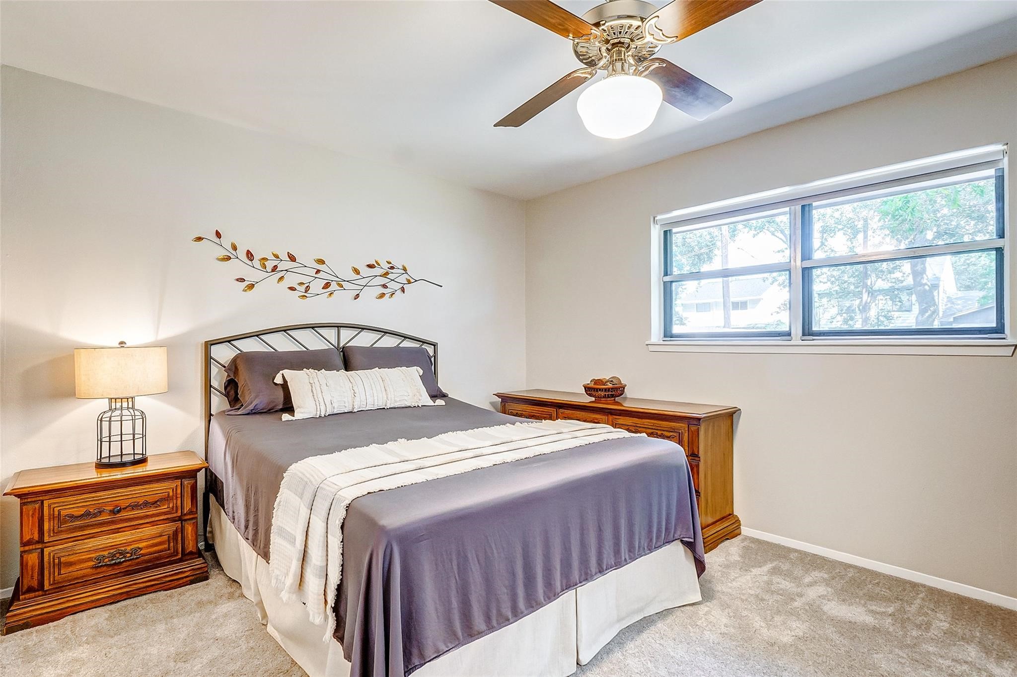 9218 Hammerly Boulevard Houston, TX 77080 - Photo 24 of 40 a bedroom with a bed and a chandelier