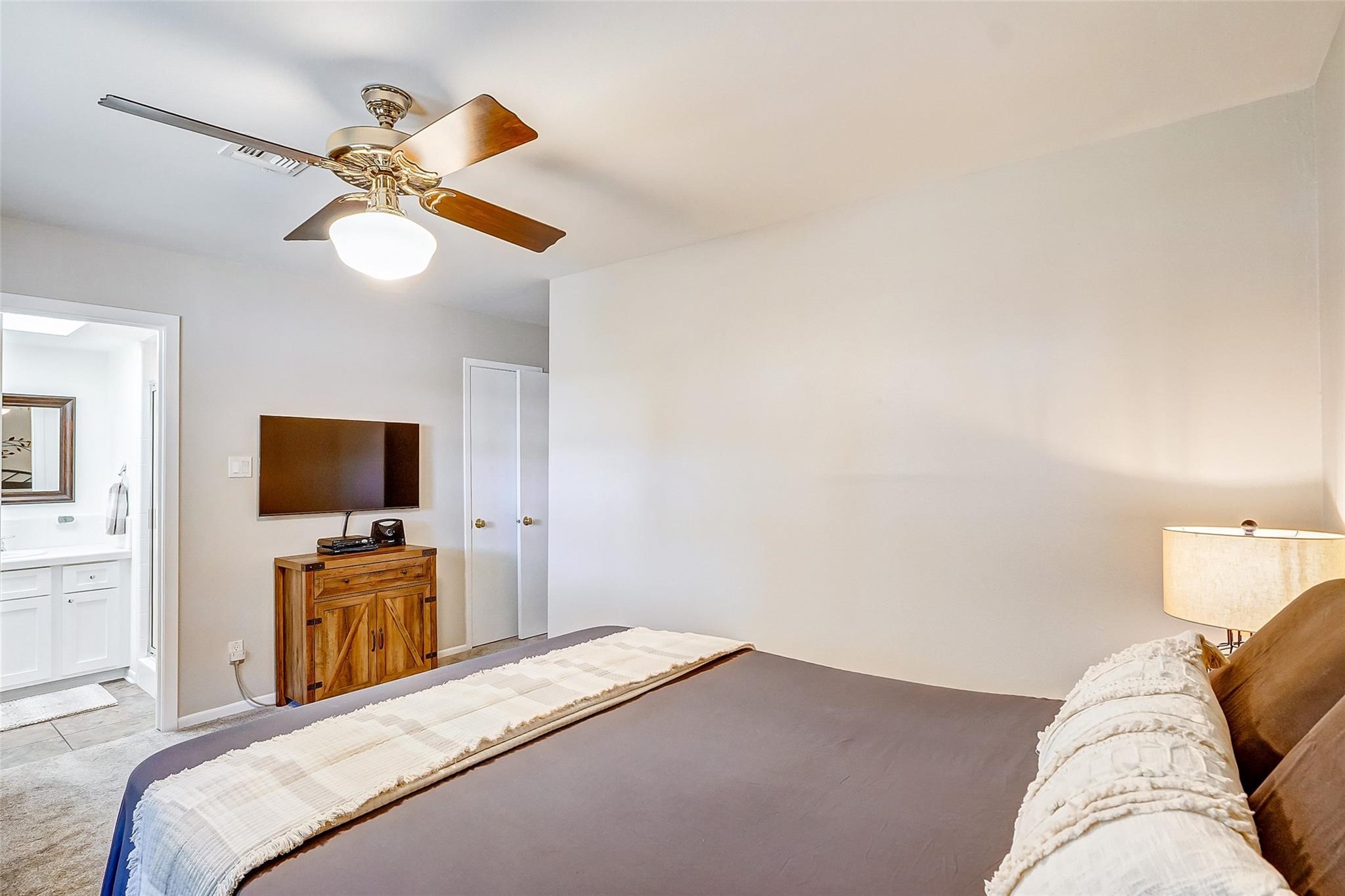9218 Hammerly Boulevard Houston, TX 77080 - Photo 25 of 40 a bedroom with a bed and a flat screen tv