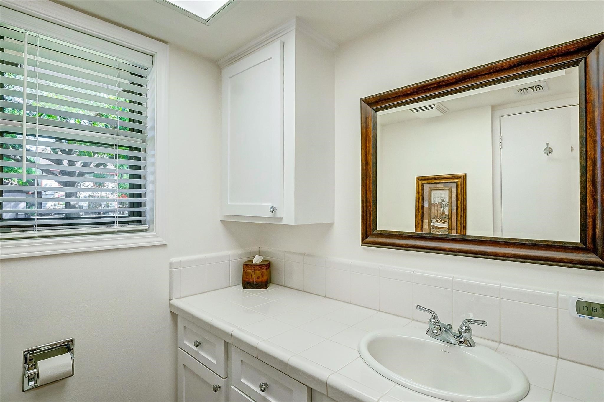 9218 Hammerly Boulevard Houston, TX 77080 - Photo 26 of 40 a bathroom with a sink and a mirror