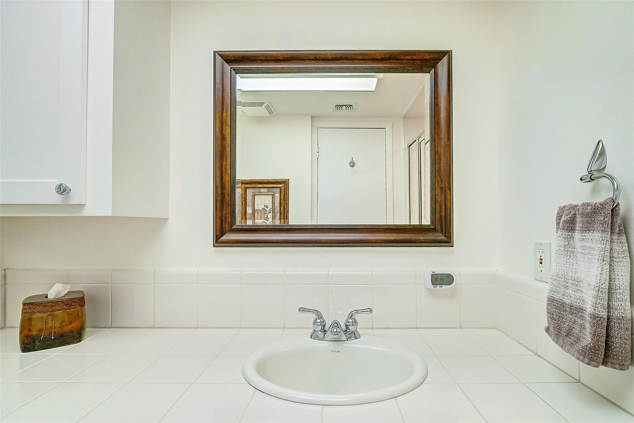 9218 Hammerly Boulevard Houston, TX 77080 - Photo 27 of 40 a bathroom with a sink a mirror and shower