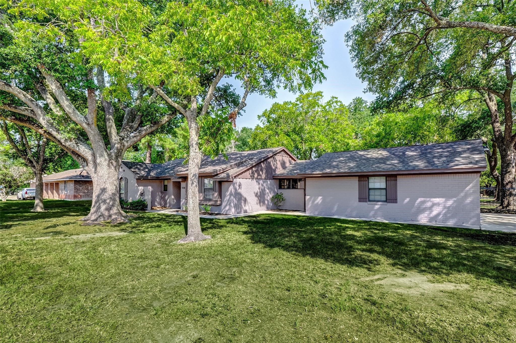 9218 Hammerly Boulevard Houston, TX 77080 - Photo 4 of 40 a backyard of a house with plants and large tree