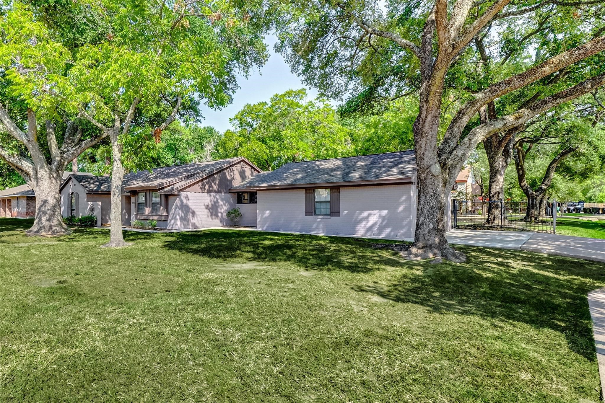9218 Hammerly Boulevard Houston, TX 77080 - Photo 5 of 40 a backyard of a house with trees and outdoor seating
