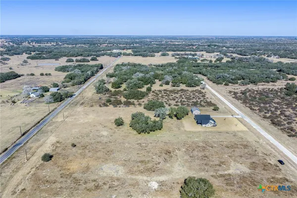 an aerial view of a house with a yard