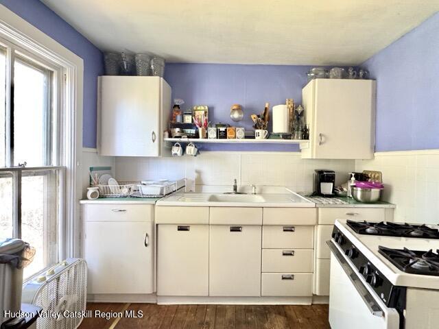 22 Liberty Street Catskill, NY 12414 - Photo 17 of 30 a kitchen with granite countertop a sink a stove and cabinets