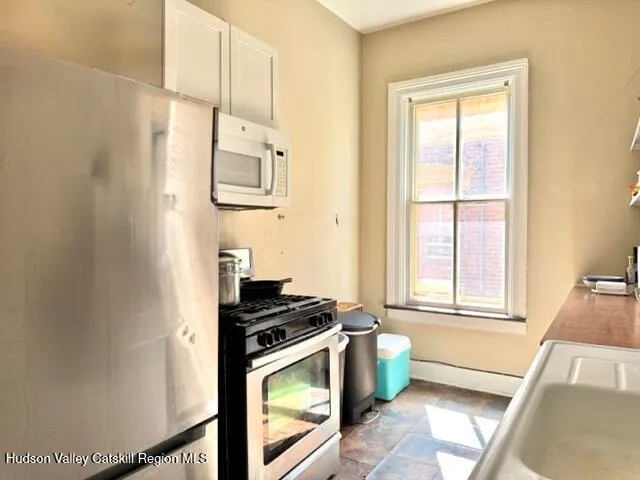 a kitchen with wooden cabinets and a stove top oven