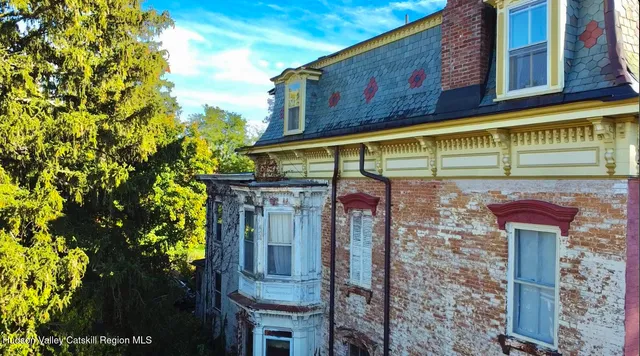 a front view of a building with glass windows and garage