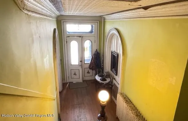 a view of front door with wooden floor