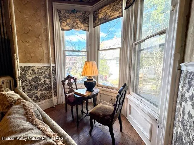 a view of a workspace with furniture and a window
