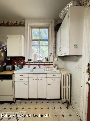 a kitchen with stainless steel appliances a stove a sink and a microwave