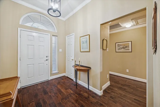 a view of a livingroom with wooden floor and furniture