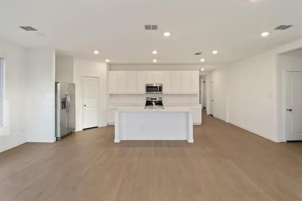 a kitchen with stainless steel appliances a sink stove and cabinets