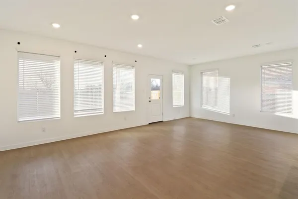 a living room with furniture kitchen view and a table