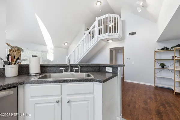 a spacious bathroom with a toilet sink and mirror