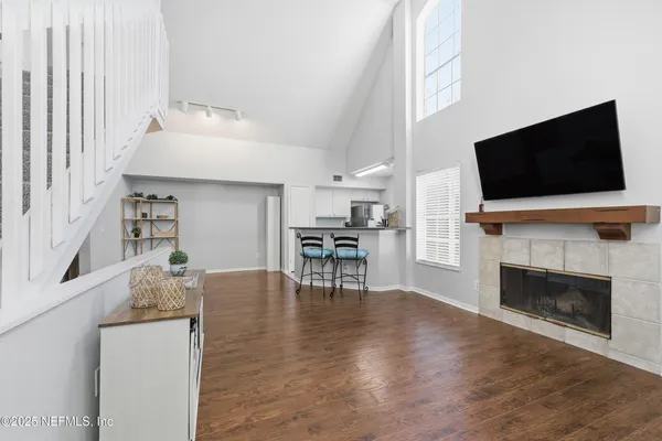a living room with furniture a fireplace and a flat screen tv