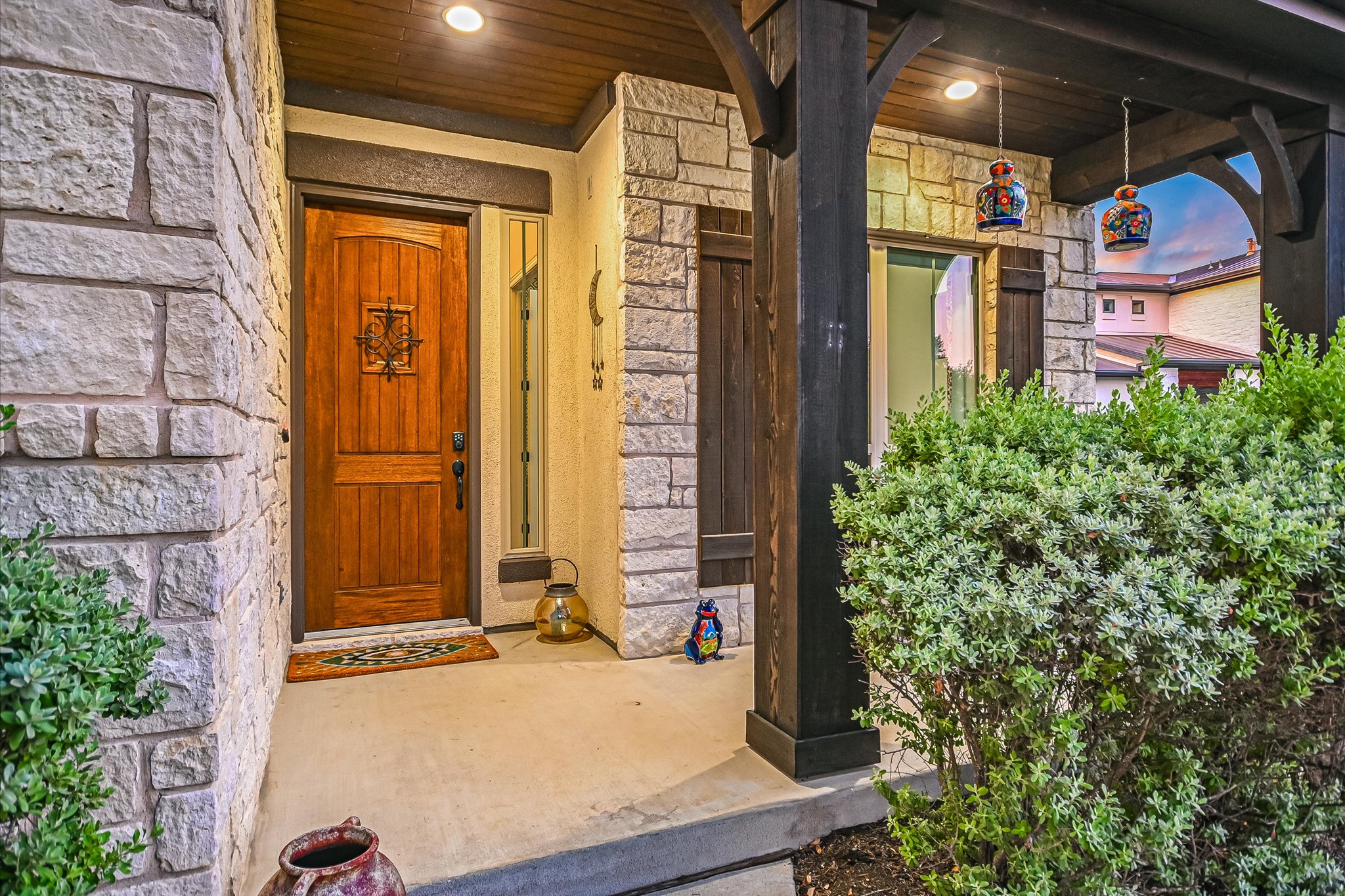 2625 Arion Circle Austin, TX 78730 - Photo 17 of 32 Property entrance with stone siding and a porch