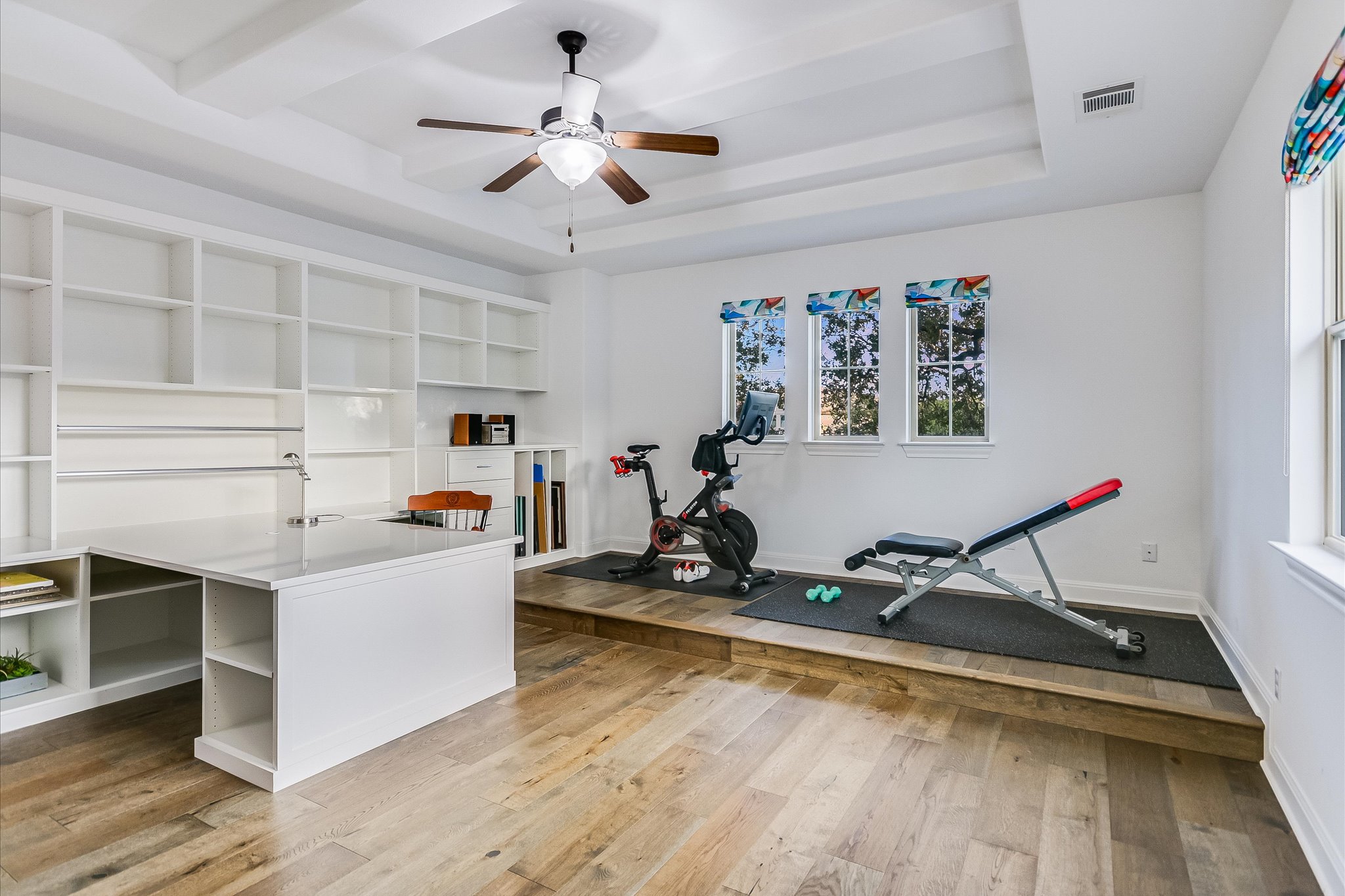 2625 Arion Circle Austin, TX 78730 - Photo 21 of 32 Exercise area with a raised ceiling, light wood-style flooring, and ceiling fan
