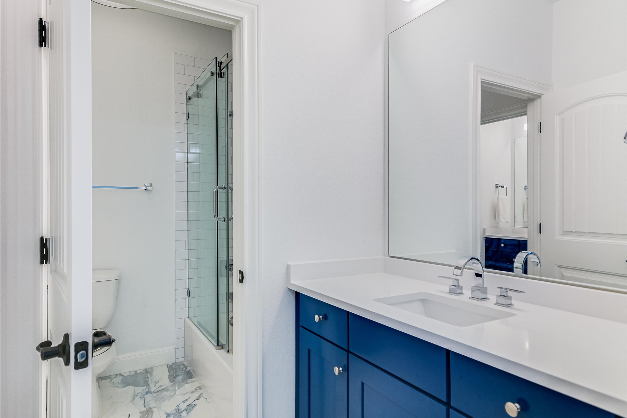 2625 Arion Circle Austin, TX 78730 - Photo 26 of 32 Bathroom featuring vanity, marble look tile flooring, and enclosed tub / shower combo