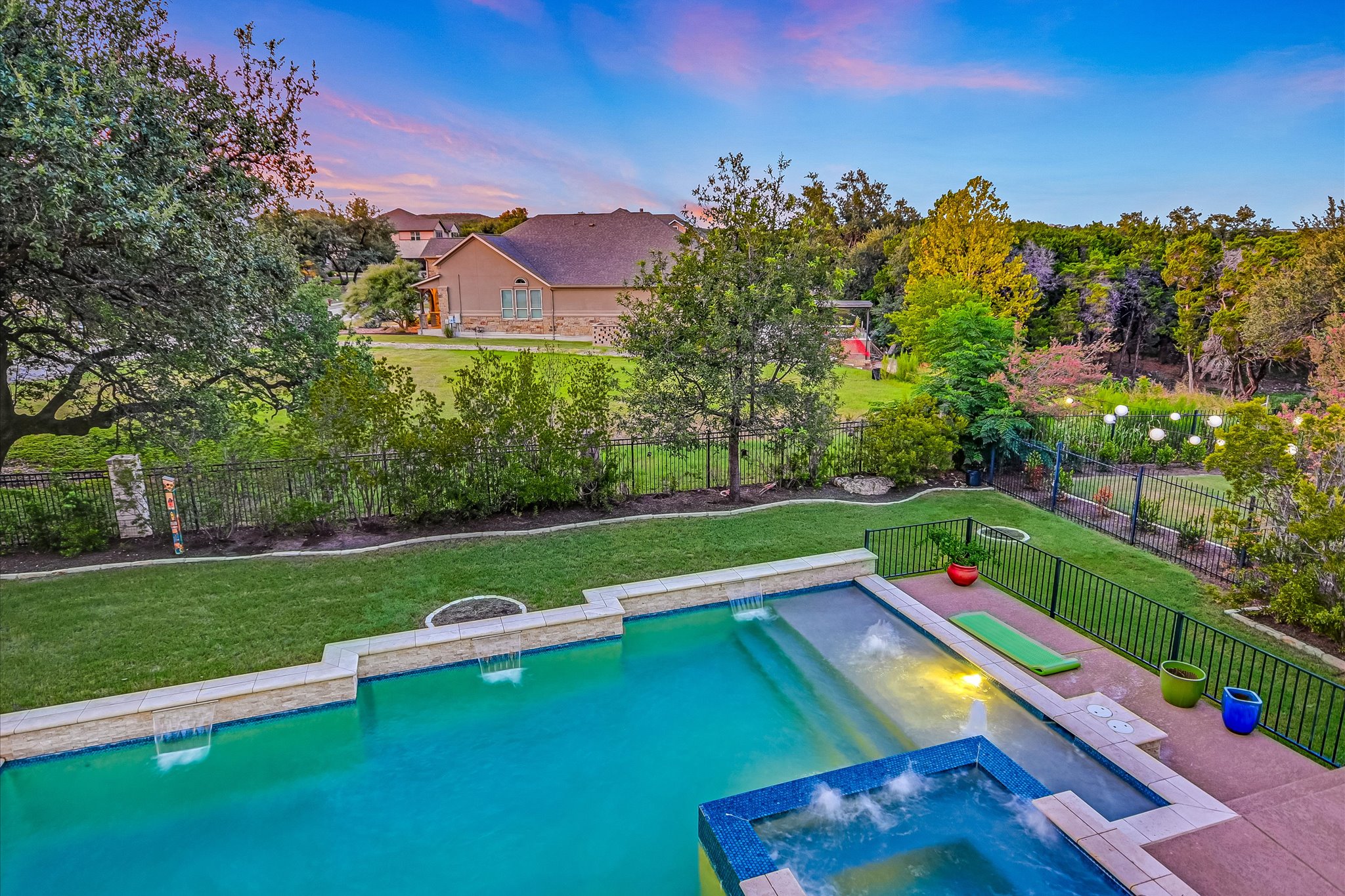 2625 Arion Circle Austin, TX 78730 - Photo 30 of 32 View of pool featuring a pool with connected hot tub and a fenced backyard