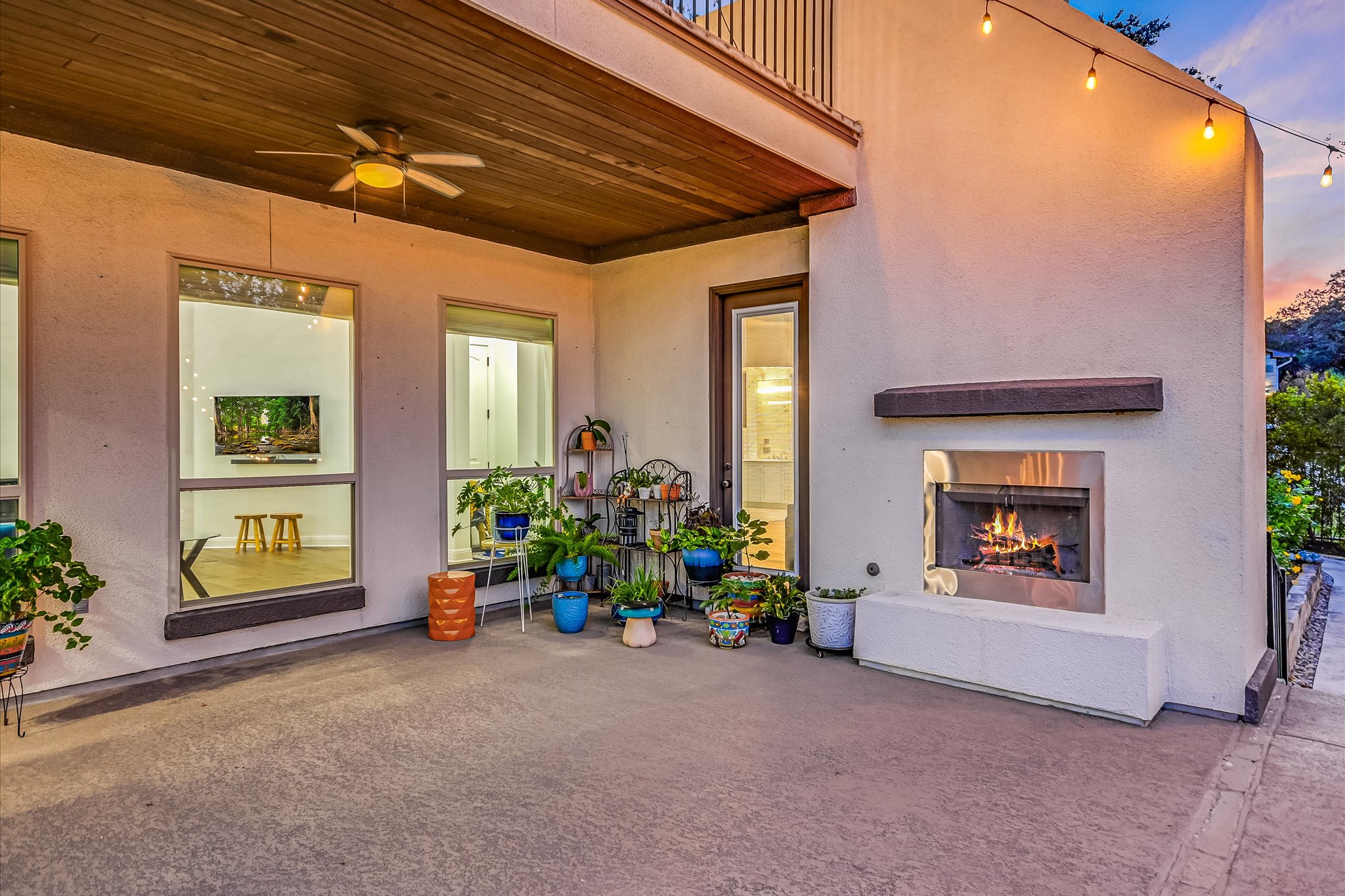 2625 Arion Circle Austin, TX 78730 - Photo 31 of 32 View of patio with a lit fireplace and ceiling fan