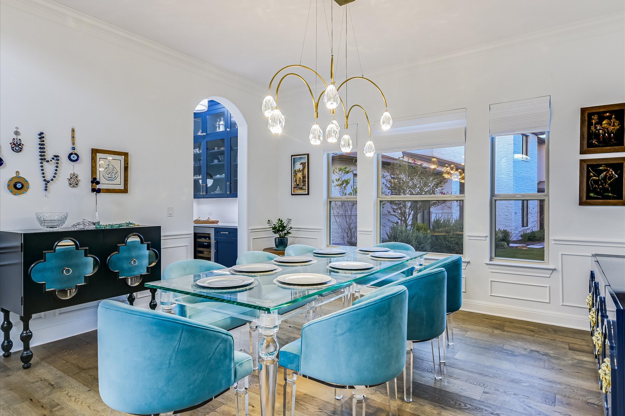 2625 Arion Circle Austin, TX 78730 - Photo 6 of 32 Dining space featuring a decorative wall, ornamental molding, a wainscoted wall, wood finished floors, and a chandelier