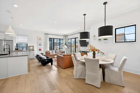 a living room with fireplace furniture and a wooden floor
