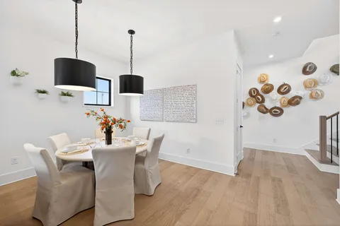a dining room with furniture and wooden floor