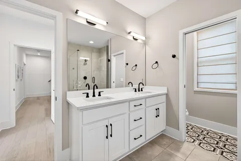 a bathroom with a double vanity sink a mirror and a