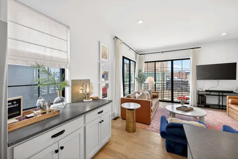 a large living room with a large window and furniture