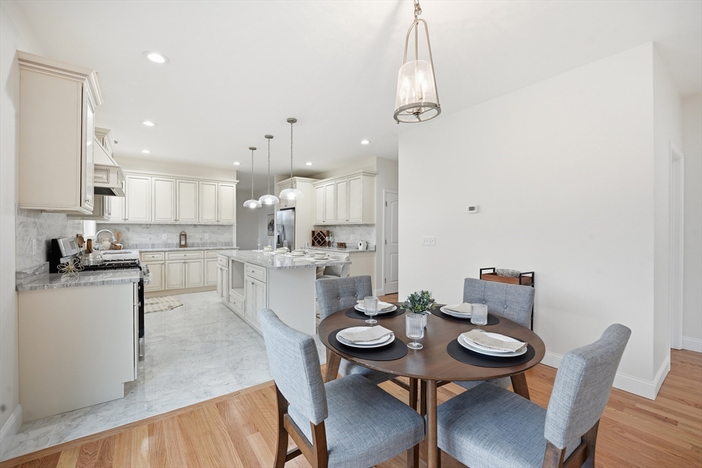 110 West Crystal Brook Drive Springfield, MA 01118 - Photo 12 of 40 a kitchen with a dining table chairs and wooden floor