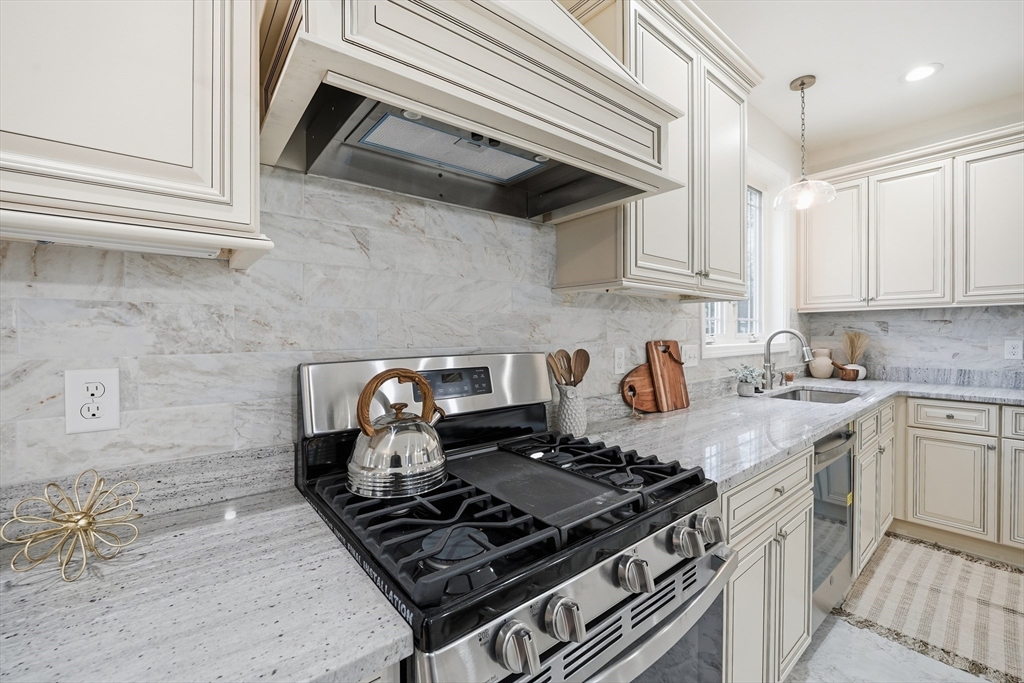 110 West Crystal Brook Drive Springfield, MA 01118 - Photo 17 of 40 a kitchen with a stove and a white cabinets