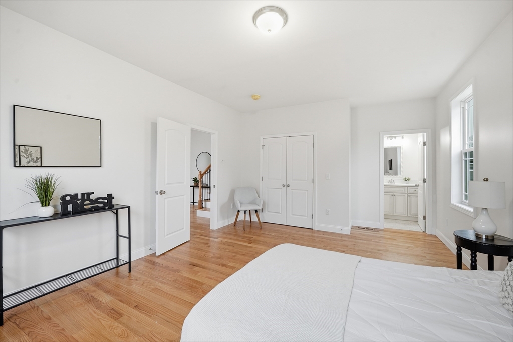 110 West Crystal Brook Drive Springfield, MA 01118 - Photo 23 of 40 a spacious bedroom with a bed and a couch