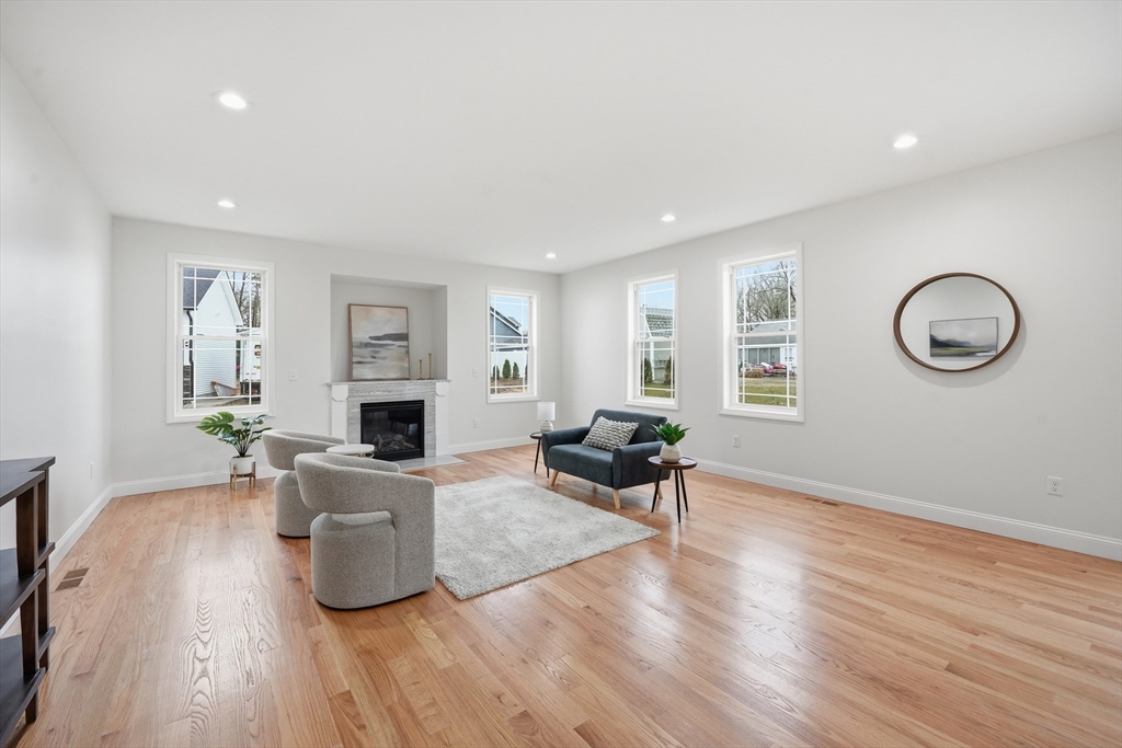 110 West Crystal Brook Drive Springfield, MA 01118 - Photo 9 of 40 a living room with furniture a fireplace and a window