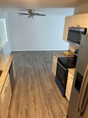 a view of an empty room and wooden floor