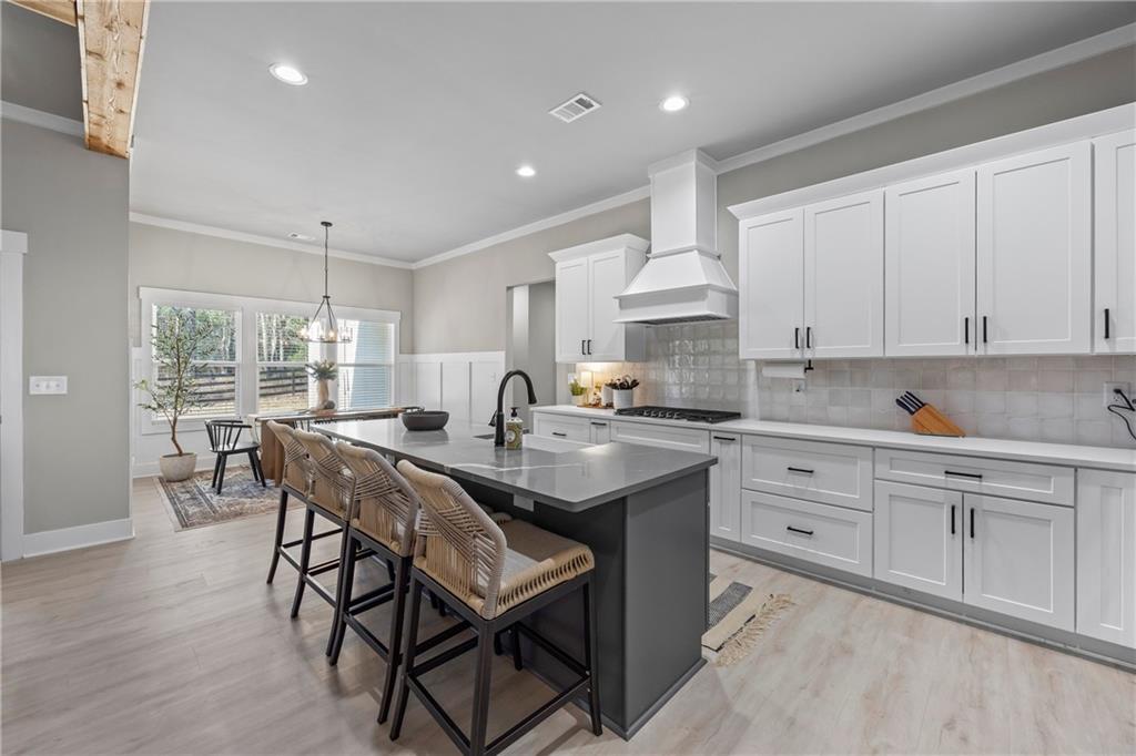 152 White Oak Way Monroe, GA 30655 - Photo 11 of 65 a kitchen with stainless steel appliances granite countertop a table chairs sink and cabinets