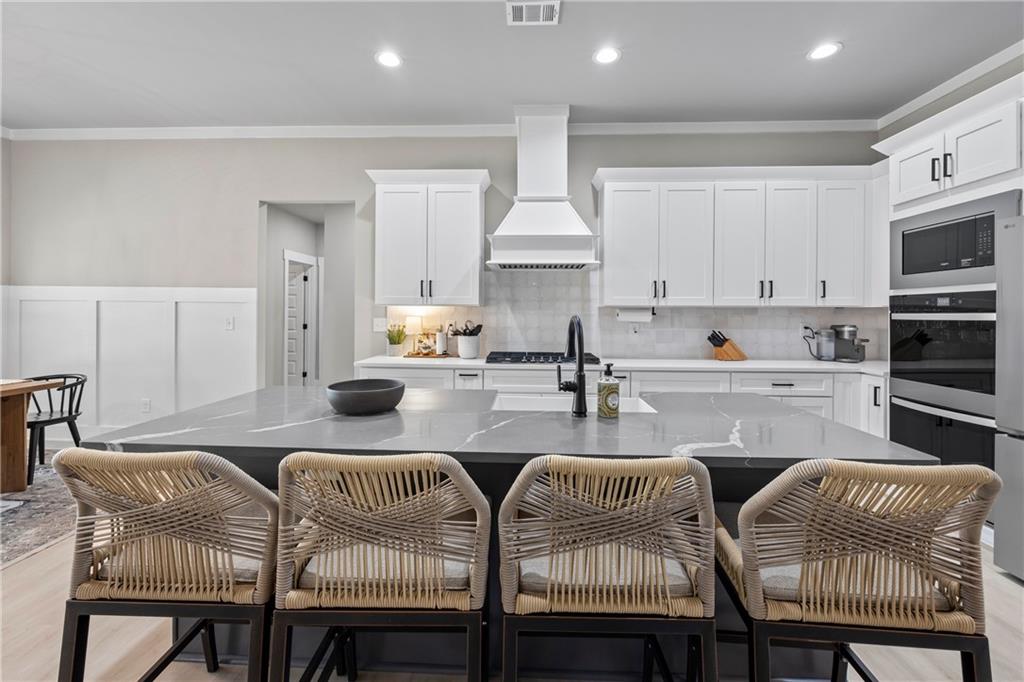152 White Oak Way Monroe, GA 30655 - Photo 12 of 65 a kitchen with granite countertop white cabinets and stainless steel appliances