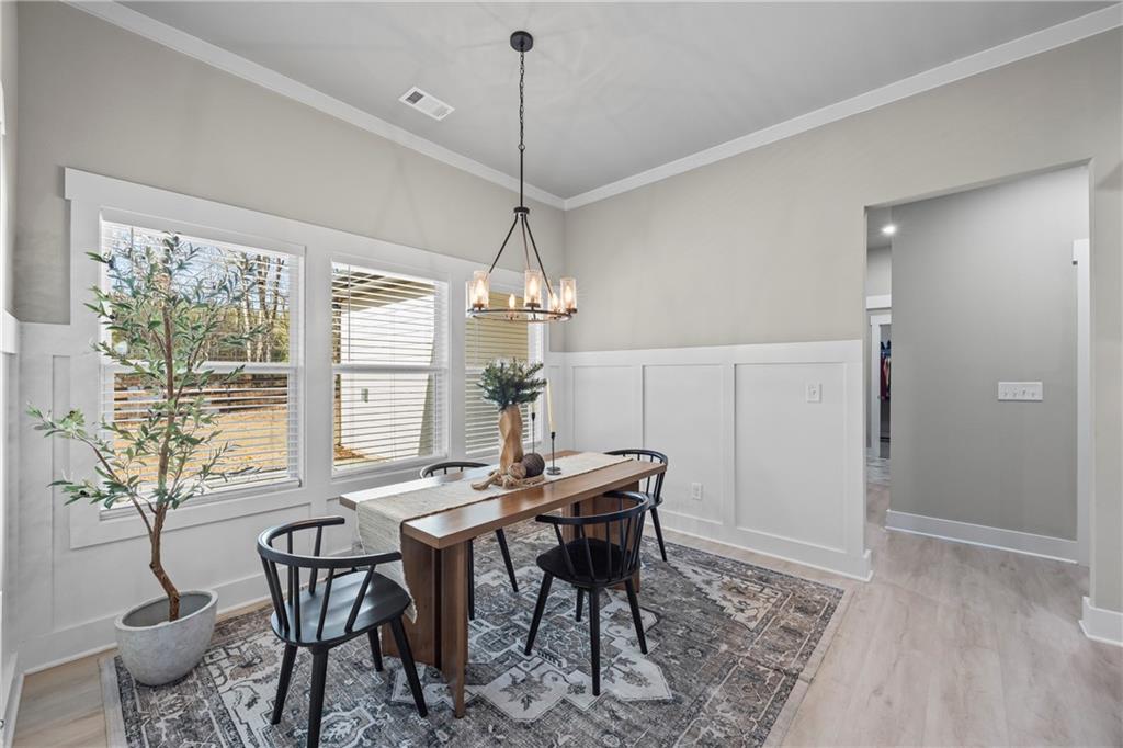 152 White Oak Way Monroe, GA 30655 - Photo 17 of 65 a view of a dining room with furniture window and wooden floor